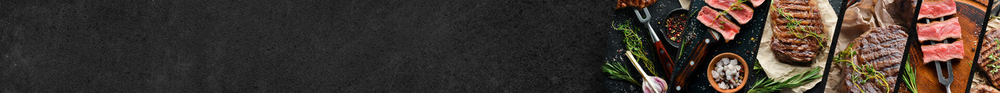 Auswahl an Fleischsorten auf Schieferhintergrund