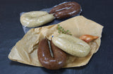 Unser Küsschen je eine Bauernleber und Blutwurst vom EIFEL Schwein mit Zwiebeln auf Backpapier