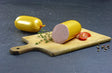 Leberwurst fein im Golddarm vom EIFEL Schwein mit Thymian Cherry Tomaten und Pefferkörnern auf Schieferhintergrund